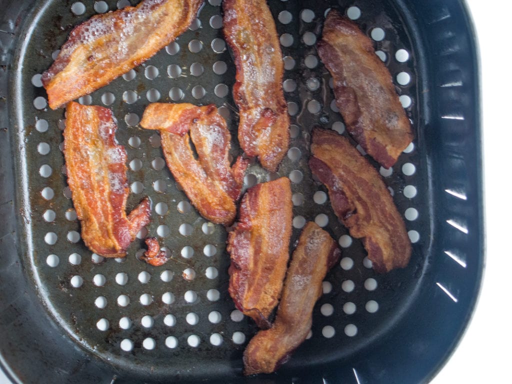 bacon cooking in air fryer basket