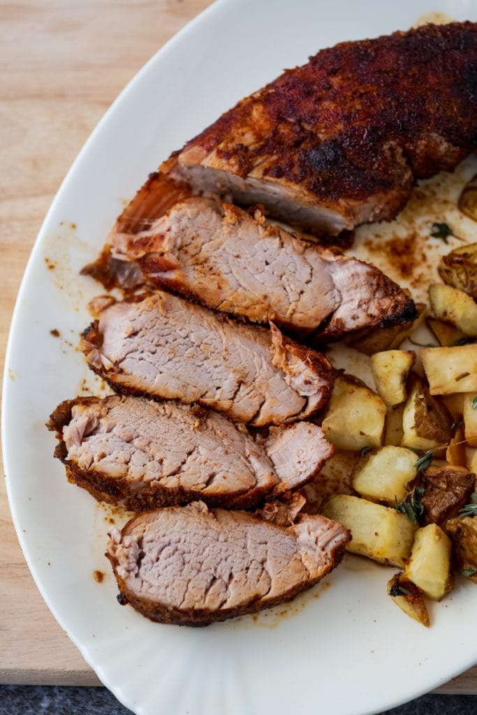overhead view of pork tenderloin on a plate with potatoes