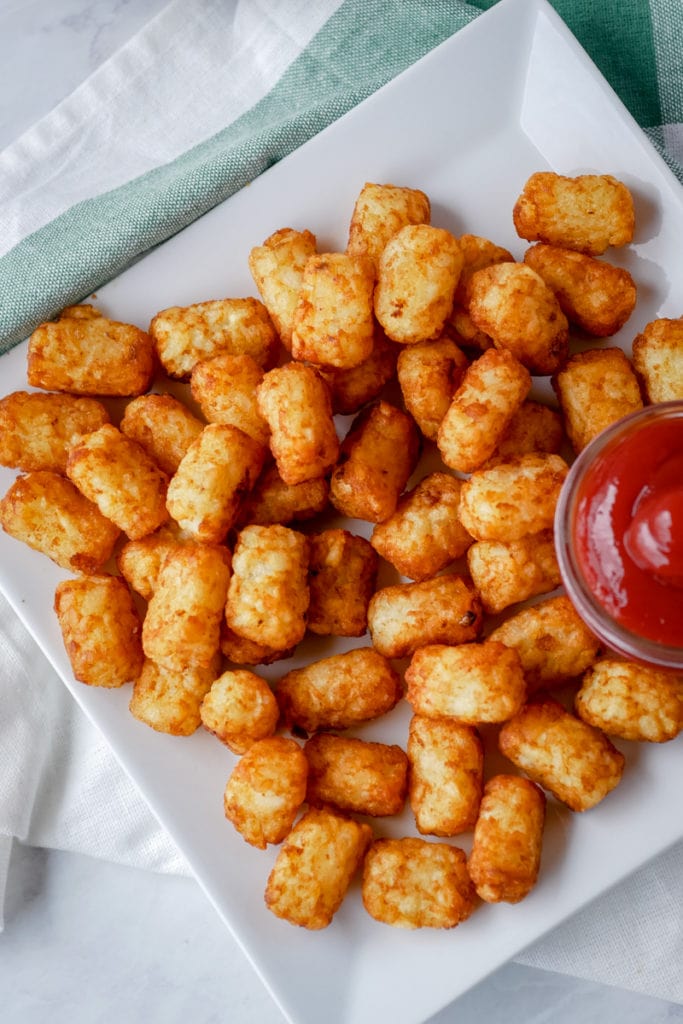 top view of air fryer tater tots with ketchup