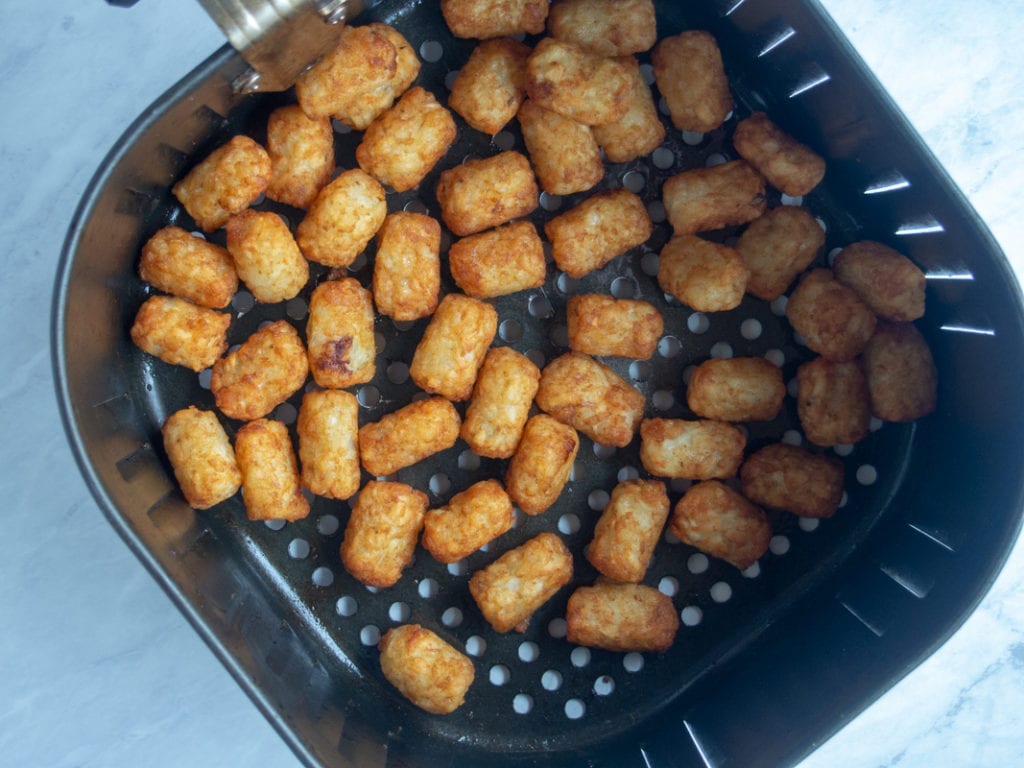 cooked tater tots in air fryer basket