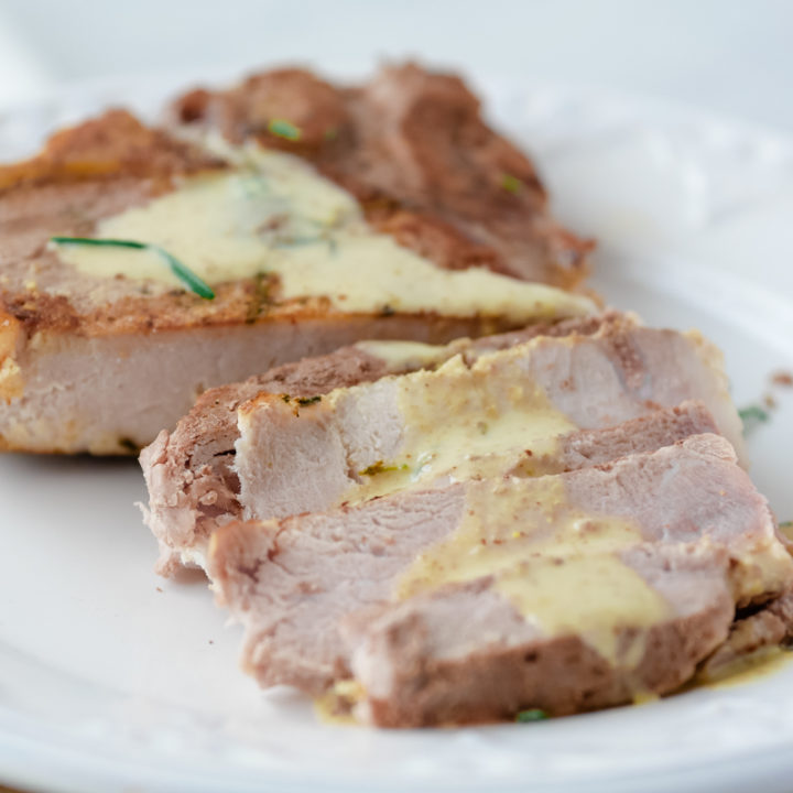 close up of sous vide pork chops with mustard cream sauce