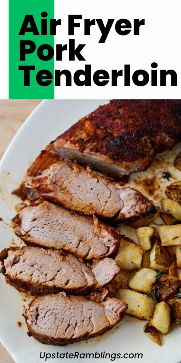 Sliced air fryer pork tenderloin with herbs and roasted potatoes on a white plate. Text overlay reads "Air Fryer Pork Tenderloin" and the website "UpstateRamblings.com" is visible at the bottom, showcasing an easy recipe for perfectly cooked air fryer pork tenderloin.