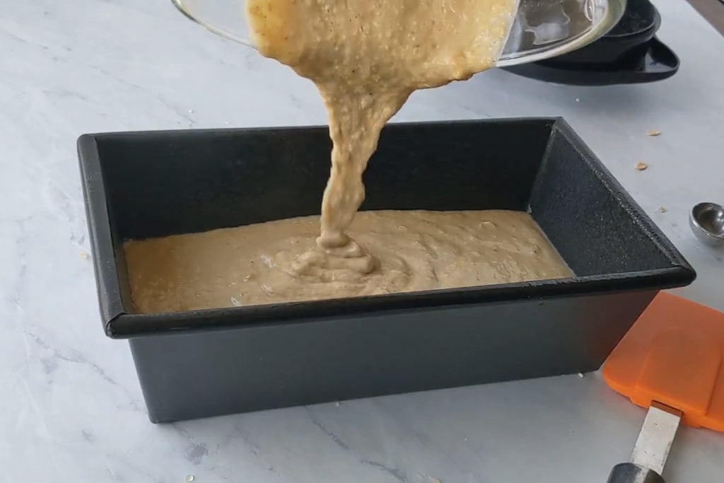 pouring banana bread into loaf pan