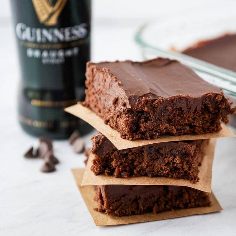 stack of brownie with bottle of Guinness in background