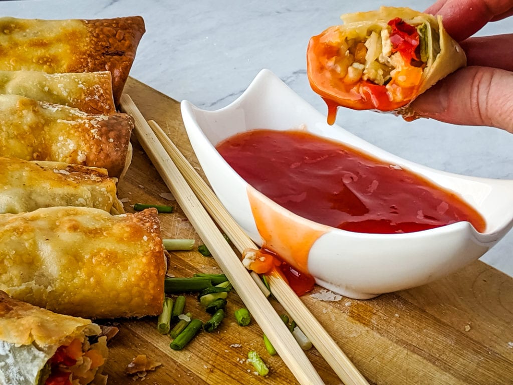 dipping egg roll in sauce