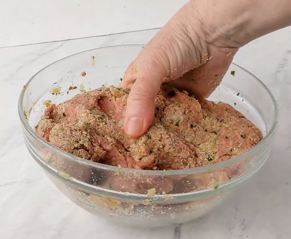 mixing meatballs ingredients in a bowl