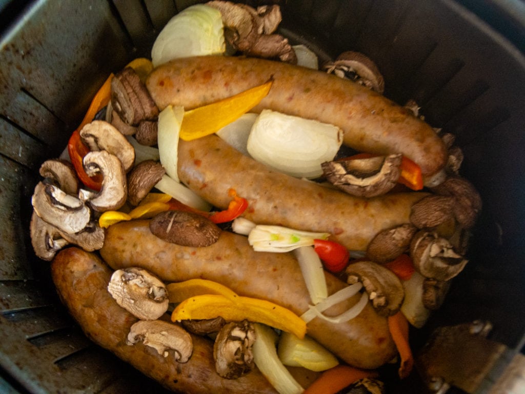 cooking sausage with peppers, onions and mushrooms