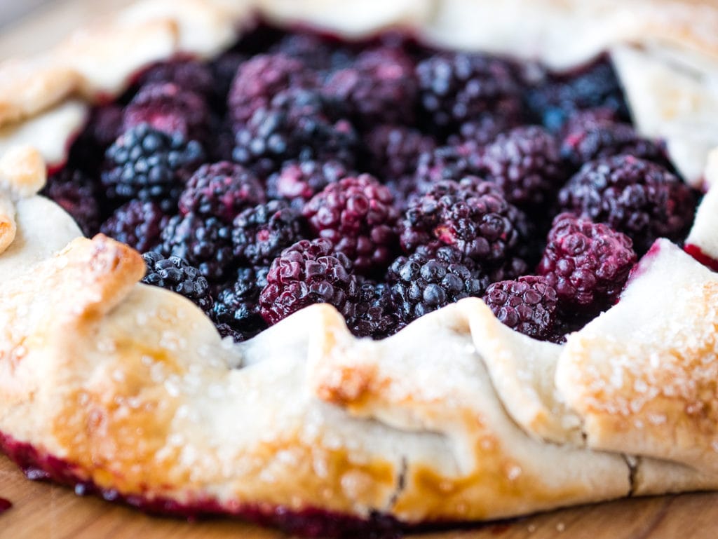 close up of blackberries in a galette