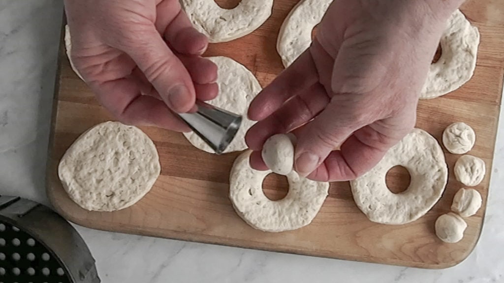 using a pastry tip to cut holes in biscuit donuts