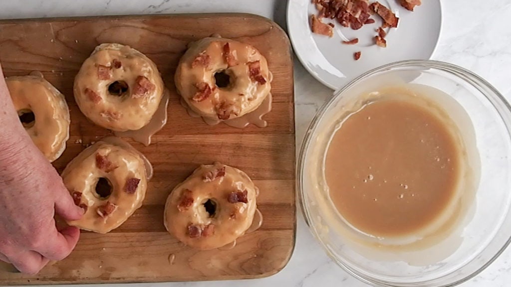 adding bacon to the maple donuts