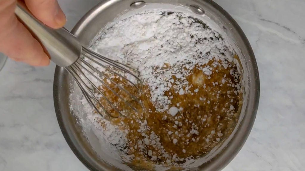 mixing the powdered sugar into the maple glaze