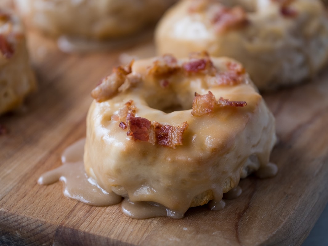 Air Fryer Maple Donuts with bacon on top.