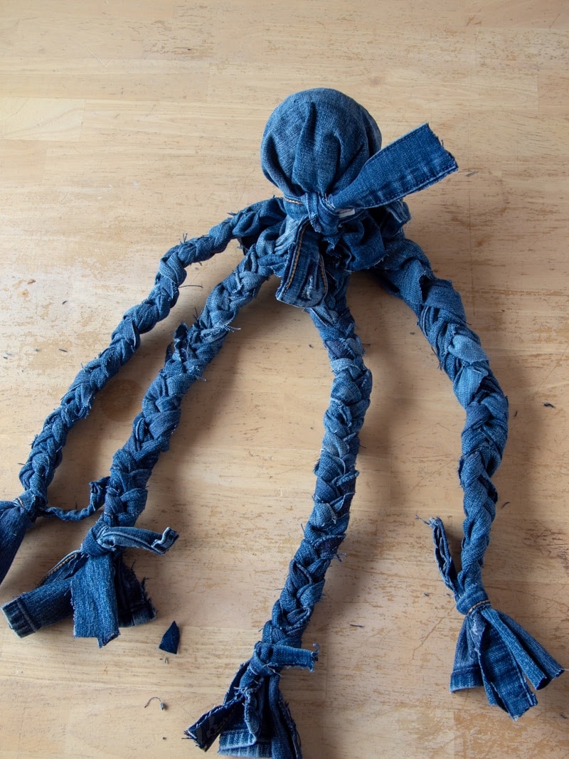 dog toy made from old pair of jeans by cutting and braiding