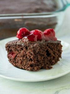 piece of chocolate cherry cake with cherries on top