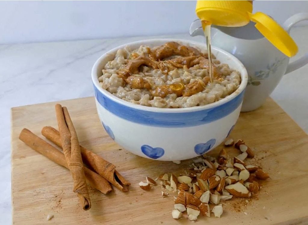 drizzling honey over a bowl of Instant Pot oatmeal