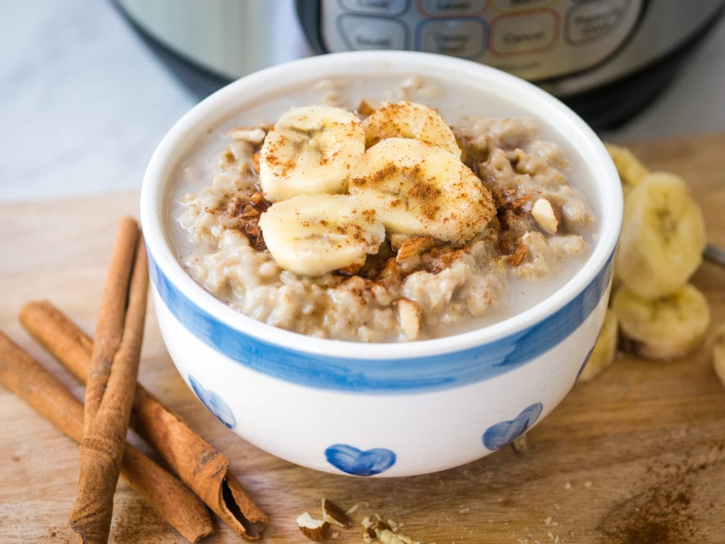 bowl of oatmeal topped with bananas in front of Instant Pot