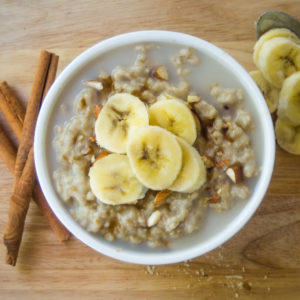 top view of oatmeal in a bowl with bananas and milk