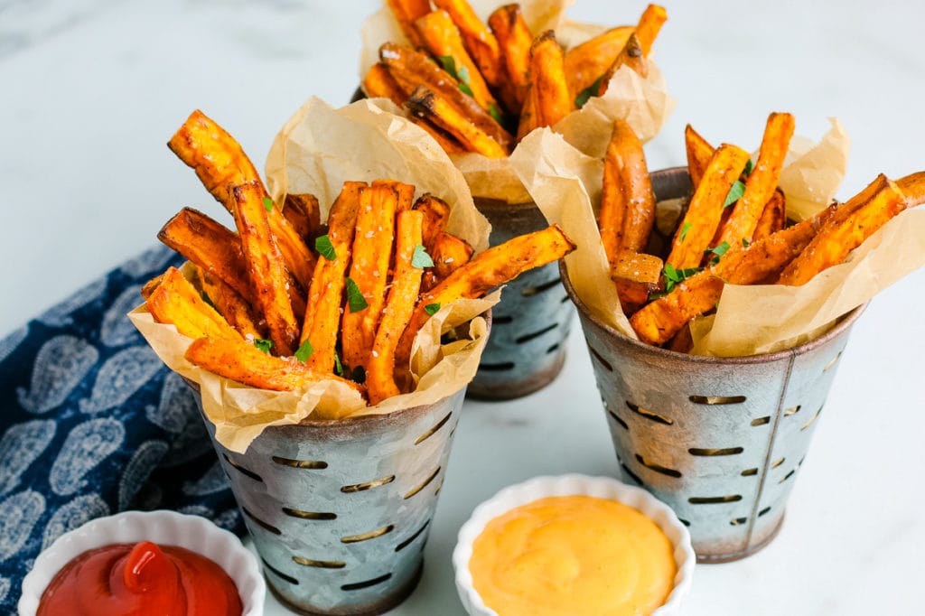 three metal bins with air fryer sweet potato fries and dipping sauce