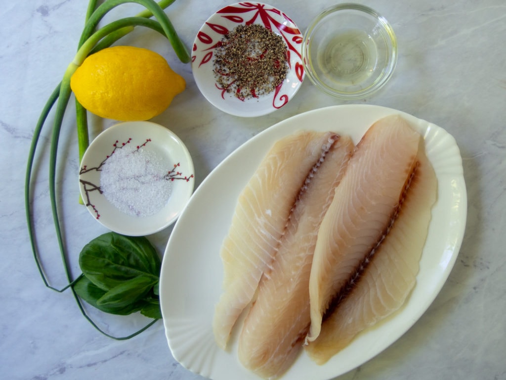 ingredients for air fryer tilapia - fish, lemon, salt, pepper, oil, garilc
