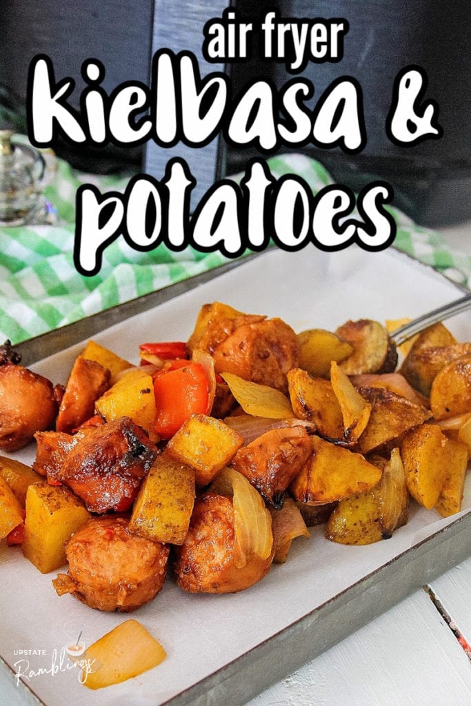 tray of kielbasa and potatoes in front of an air fryer