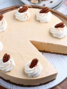 Pumpkin cheesecake with pecans on a plate.