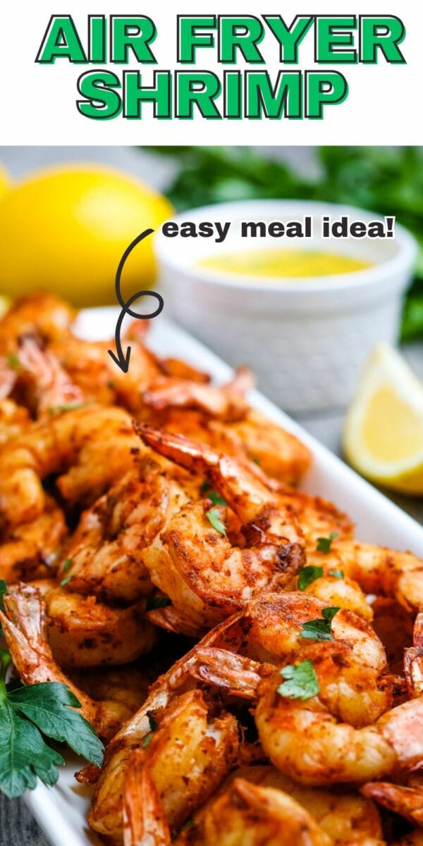 A plate of seasoned air fryer shrmip garnished with herbs, positioned next to lemon slices and a dipping sauce. Text reads "Air Fryer Shrmip" at the top and "easy meal idea!" with an arrow pointing to the shrimp.