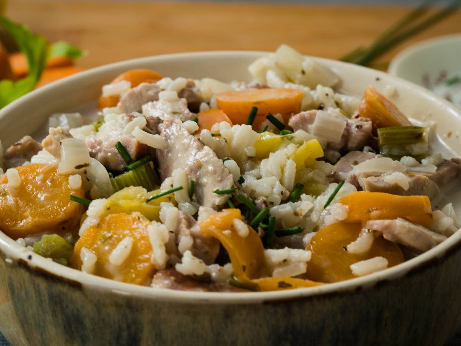 Bowl of turkey soup with rice and carrots.