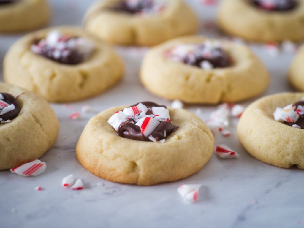 thumbprint cookie filled iwth semisweet chocolate and topped with crushed candy cane