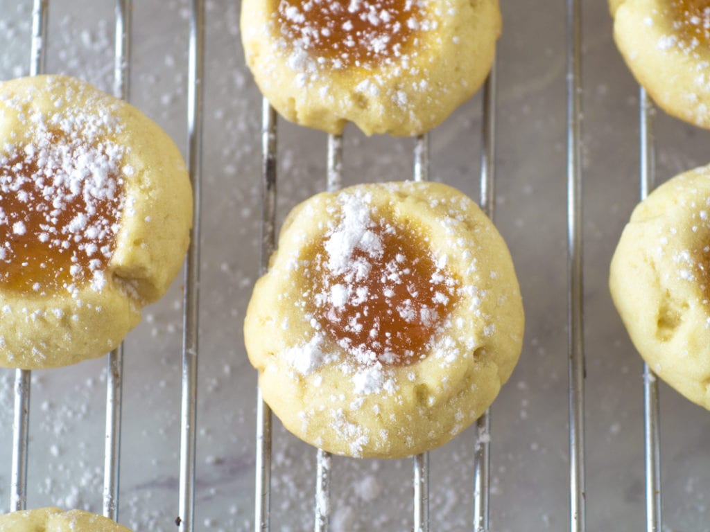 closeup of thumbprint cookie with apricot jam
