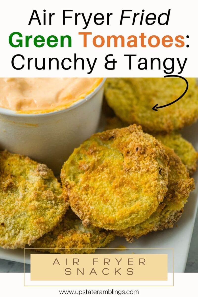 Close-up of air fryer fried green tomatoes on a plate, served with dipping sauce in a small white bowl. Text overlay describes them as crunchy and tangy air fryer snacks.
