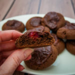 holding a chocolate cherry cookie