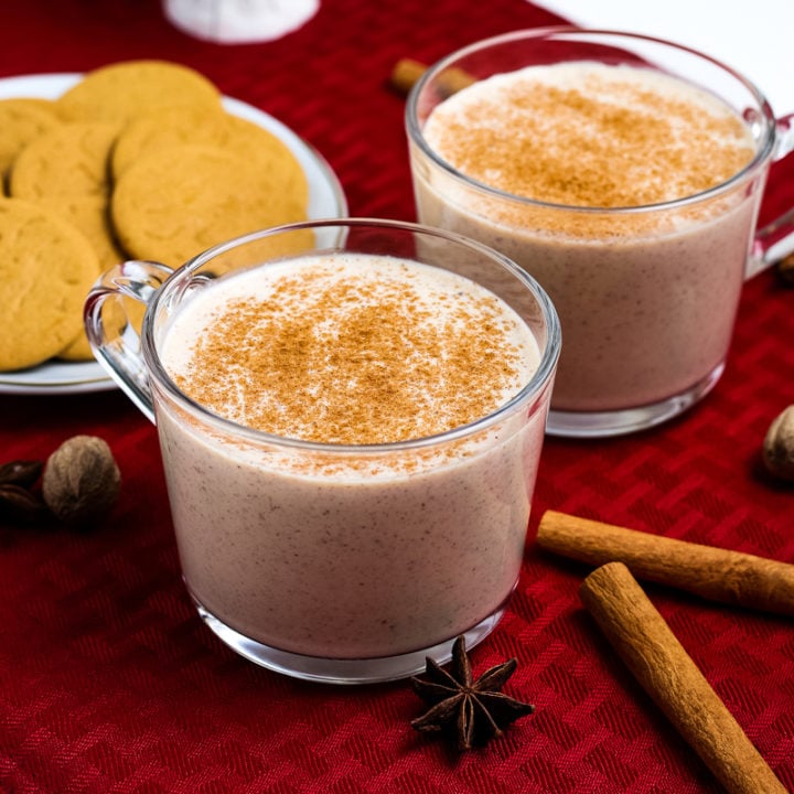 2 mugs of sous vide eggnog with cookies in the background