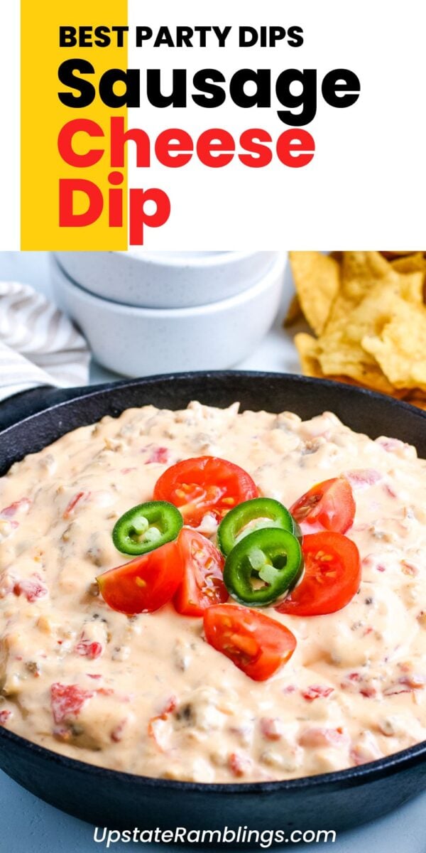 A hot skillet of sausage cheese dip, topped with sliced tomatoes and jalapeños, sits ready to enjoy, surrounded by crisp tortilla chips and a bowl in the background.