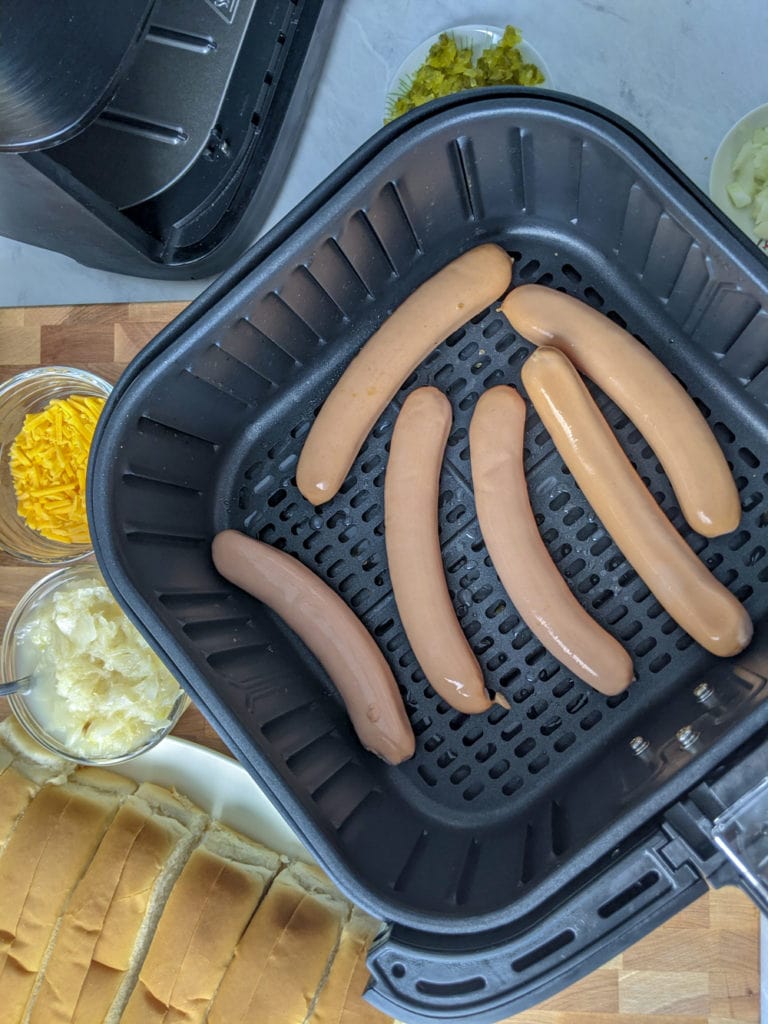 hot dogs in air fryer basket before cooking