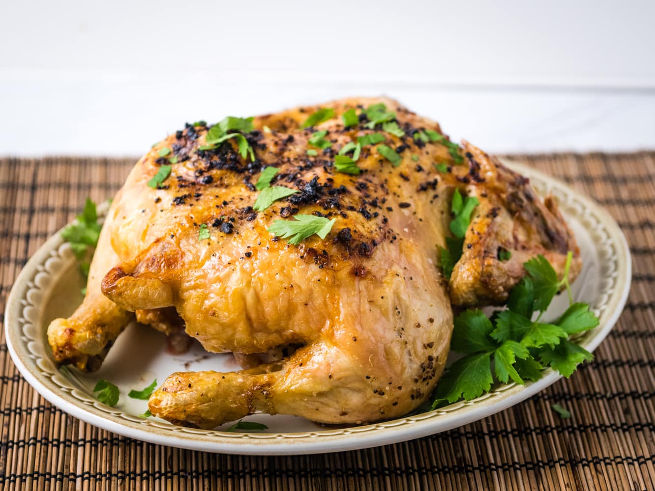 Whole chicken cooked in the air fryer with lemon and herbs.