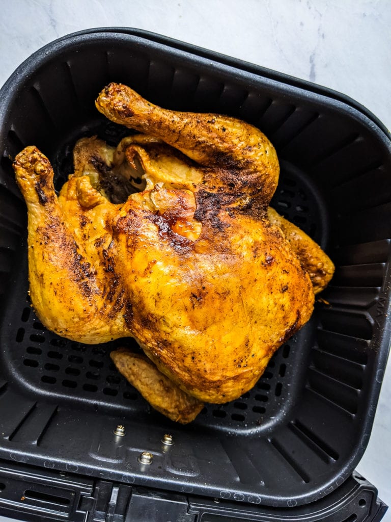 chicken in air fryer basket after cooking