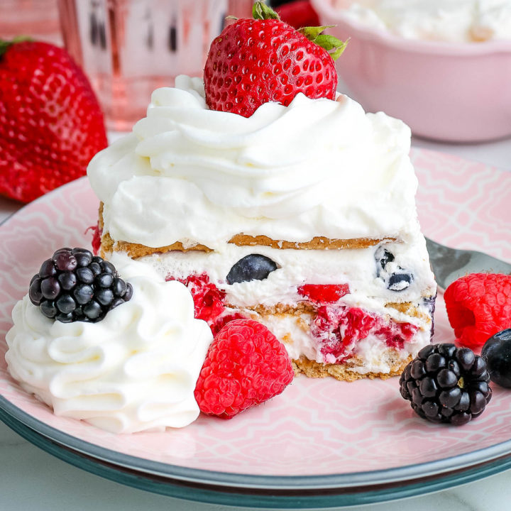 icebox cake with summer berries on a pink plate