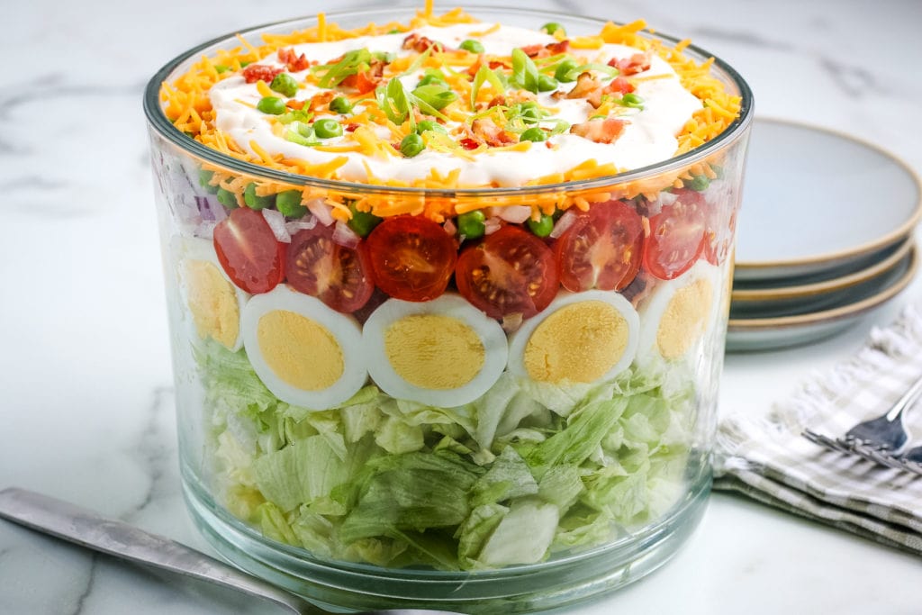 side view of 7 layer salad in a trifle bowl