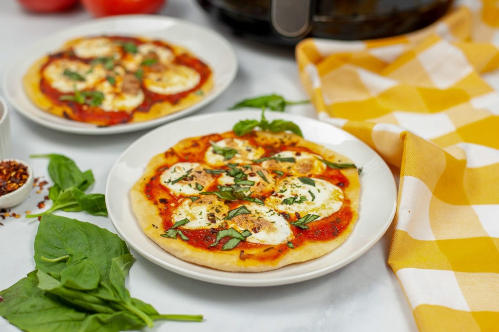 margherita pizza in front of air fryer