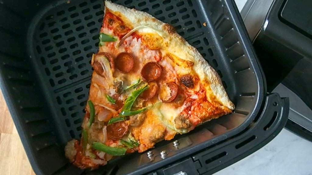 pizza being reheated in the air fryer
