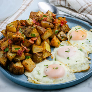 breakfast potatoes and eggs on a plate