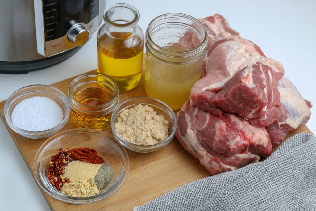 The ingredients for instant pot pulled pork on a cutting board.