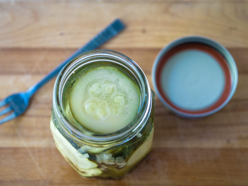 open jar of zucchini pickles