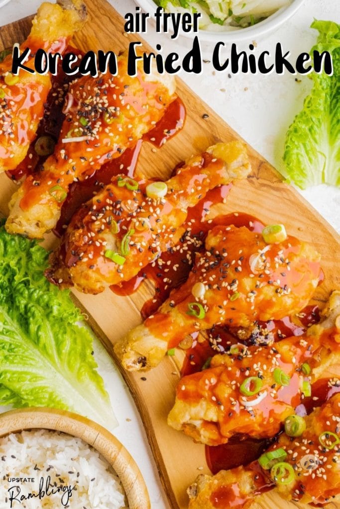 air fryer Korean fried chicken on a wooden cutting board with lettuce and rice