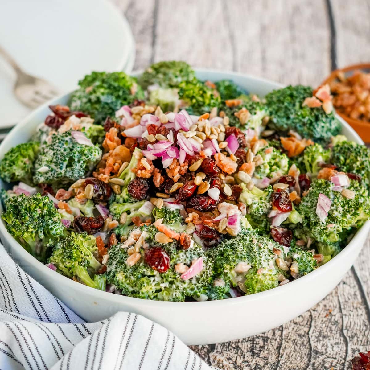 A close shot of a fork full of broccoli salad.