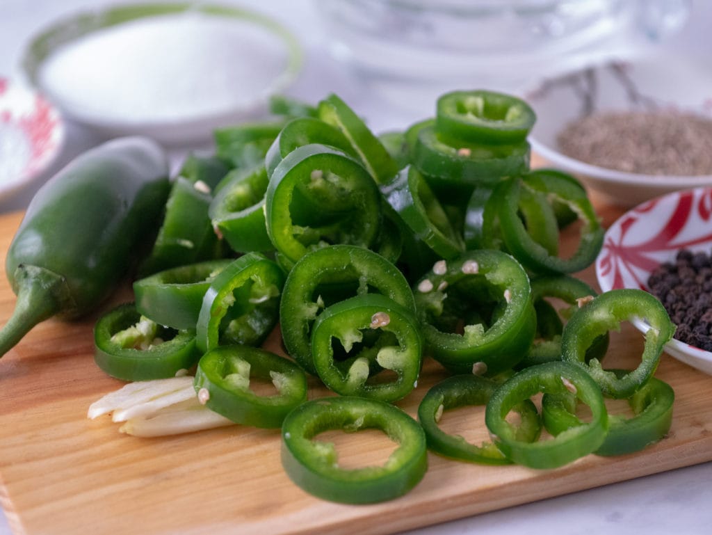 sliced jalapenos on a cutting board