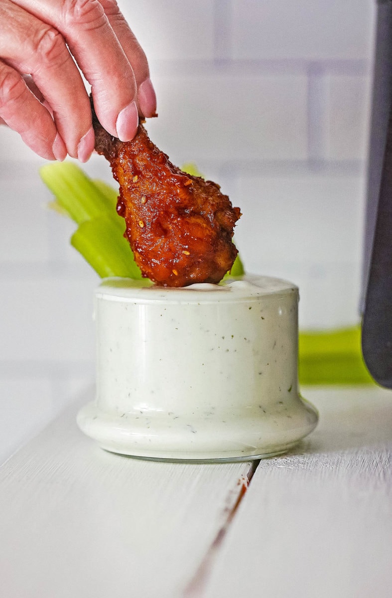 dipping the wings in ranch sauce