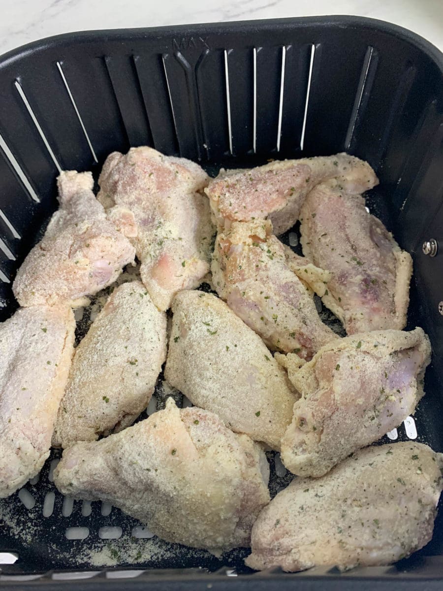 wings in air fryer basket before cooking