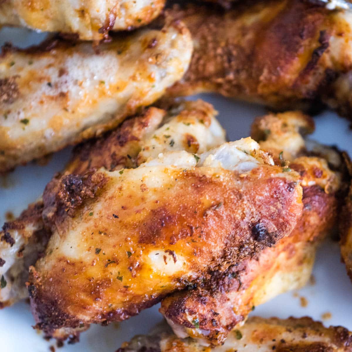 Plate of air fryer ranch wings with tongs in the background.