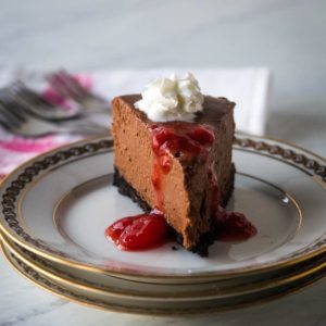cheesecake with whipped cream and strawberry sauce